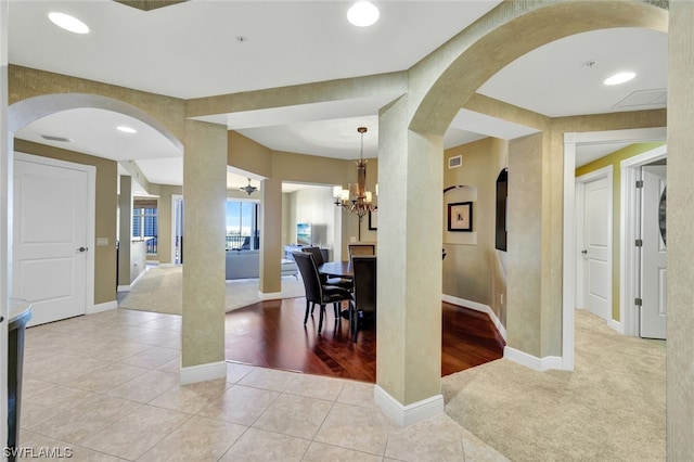 dining space featuring an inviting chandelier and light wood-type flooring