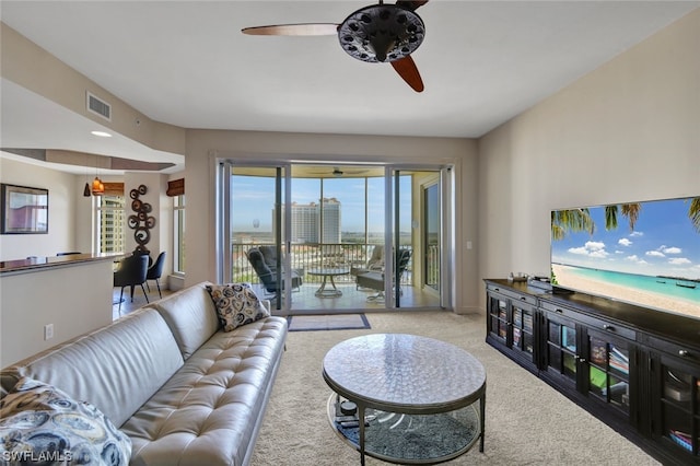 carpeted living room featuring ceiling fan