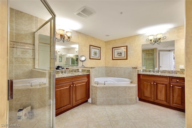 bathroom with plus walk in shower, tile patterned flooring, vanity, and a chandelier