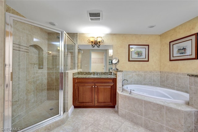 bathroom with tile patterned floors, vanity, and independent shower and bath