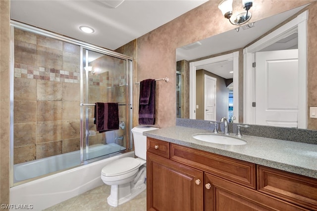 full bathroom with tile patterned flooring, vanity, toilet, and shower / bath combination with glass door