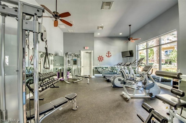 workout area with a towering ceiling and ceiling fan