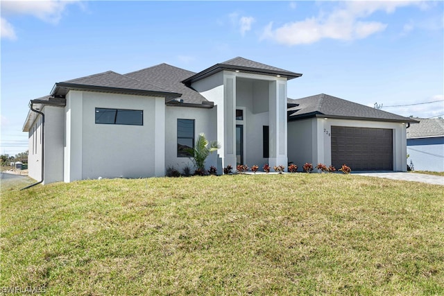 prairie-style house with a garage and a front lawn