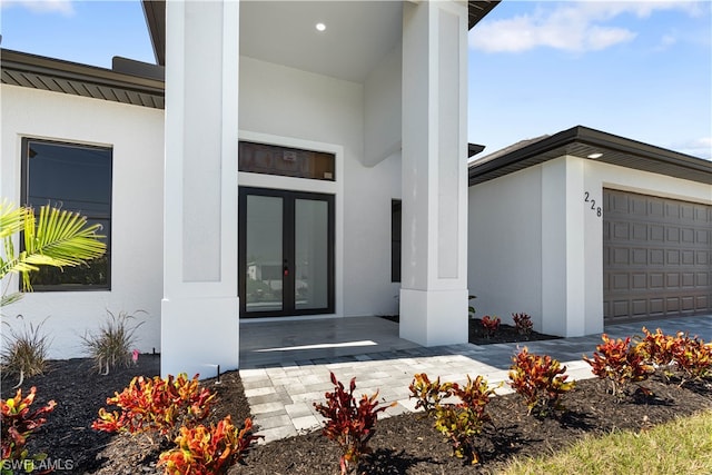 entrance to property featuring french doors and a garage