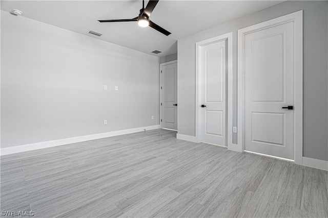 unfurnished bedroom with ceiling fan and light wood-type flooring