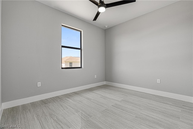 spare room featuring light wood-type flooring and ceiling fan