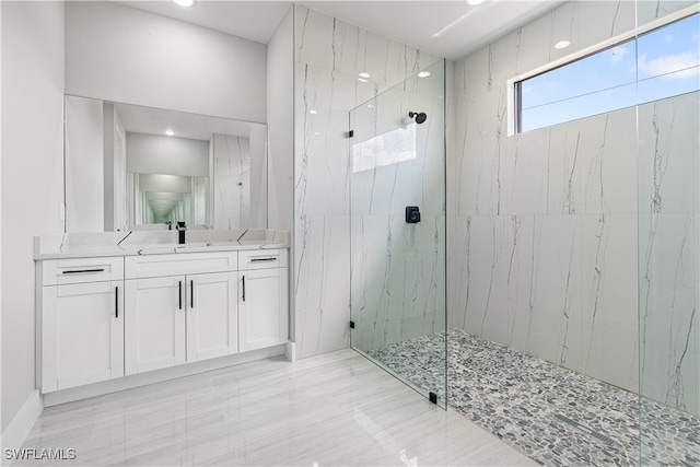 bathroom with vanity and a shower with door