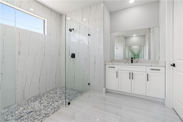 bathroom featuring tiled shower, vanity, and tile patterned floors