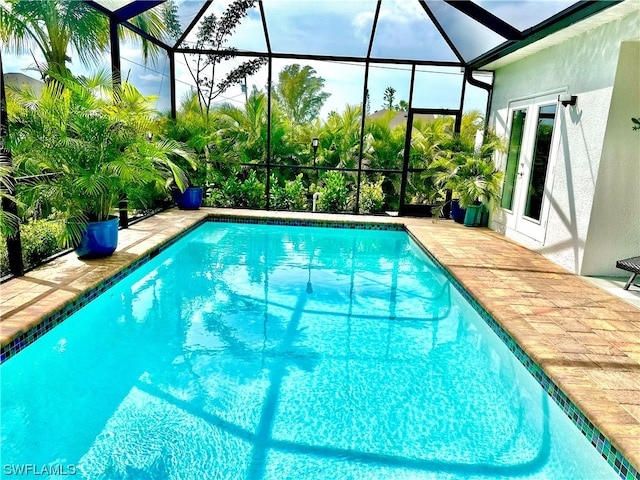 view of swimming pool featuring a lanai