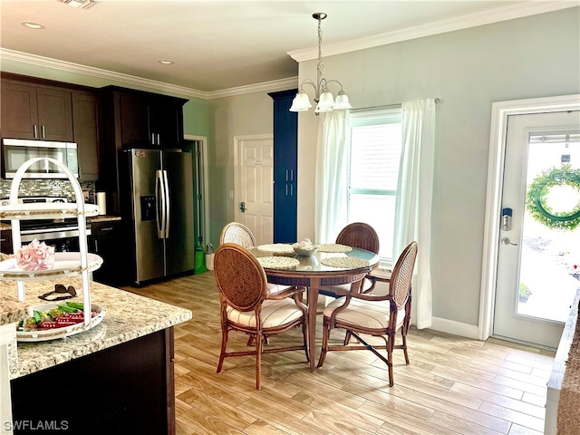 dining room with crown molding, a chandelier, and light wood-type flooring