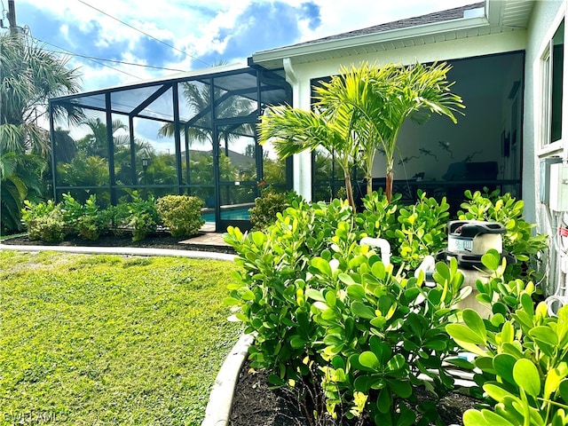 view of yard with glass enclosure