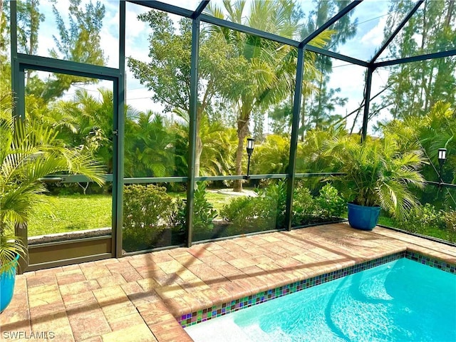 view of swimming pool with a patio and glass enclosure