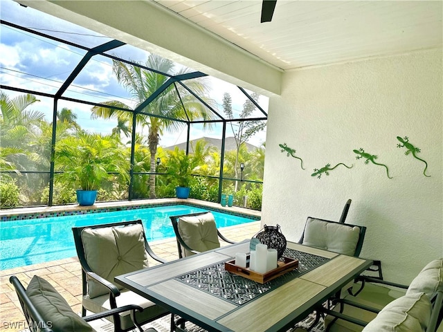 view of pool featuring a patio and glass enclosure