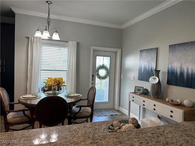 dining area featuring crown molding and a chandelier