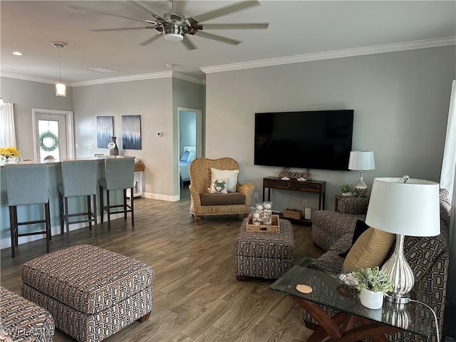 living room with hardwood / wood-style flooring, ceiling fan, and ornamental molding