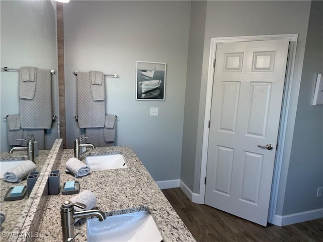 bathroom with hardwood / wood-style flooring and vanity