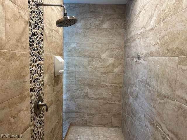 bathroom with a tile shower