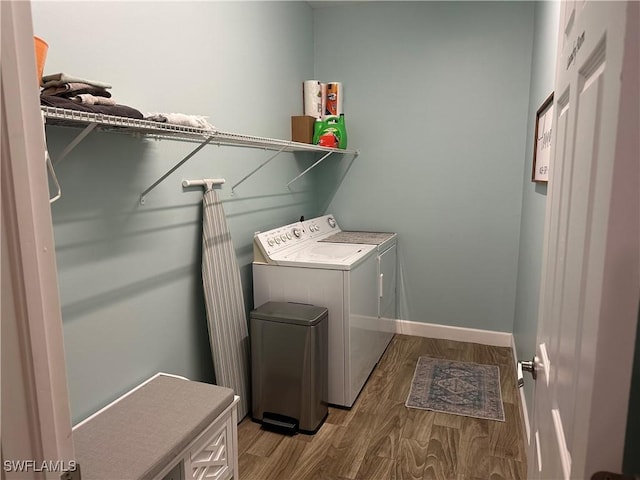 laundry area with hardwood / wood-style flooring and washer and dryer