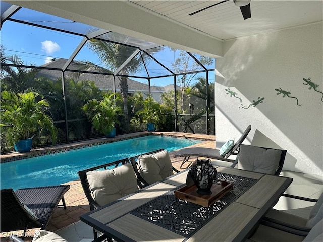 view of swimming pool with an outdoor living space, a patio, glass enclosure, and a mountain view