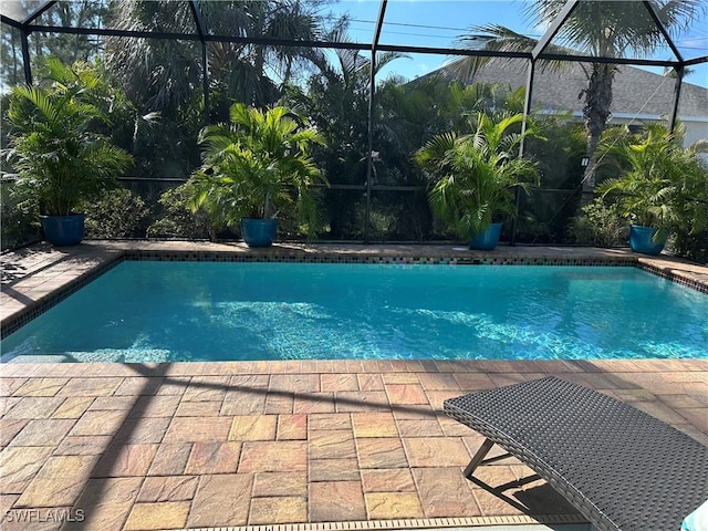 view of pool featuring a patio and glass enclosure