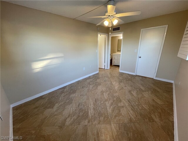 unfurnished bedroom with connected bathroom and ceiling fan