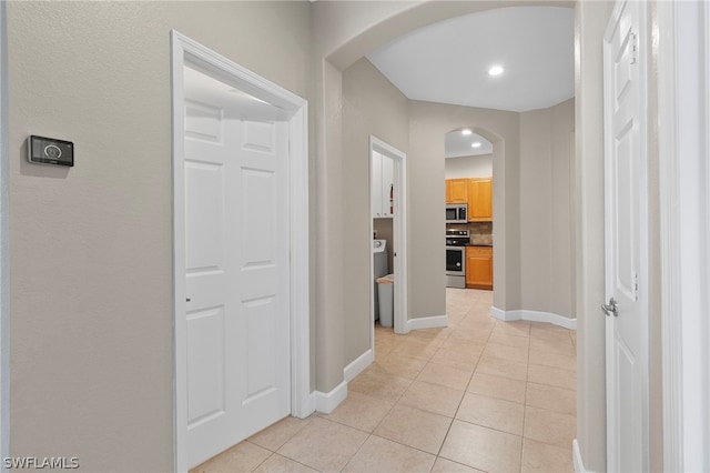 hall featuring light tile flooring