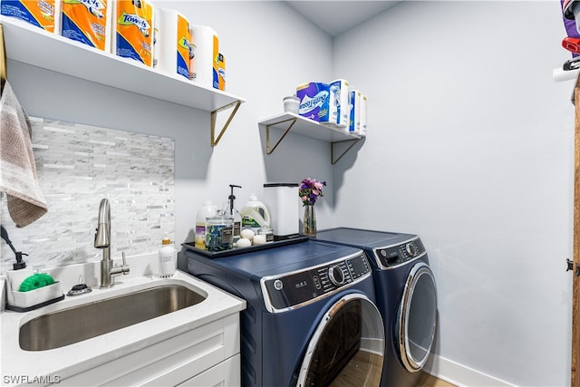 washroom featuring separate washer and dryer and sink