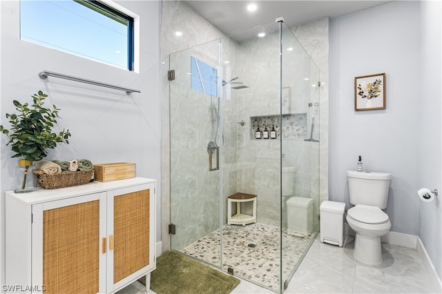 bathroom with toilet, a shower with shower door, and tile flooring