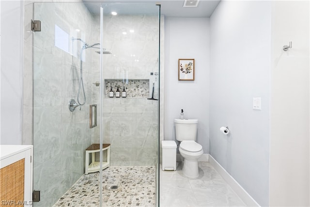 bathroom featuring an enclosed shower, vanity, tile flooring, and toilet