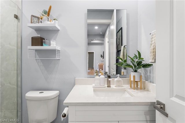 bathroom featuring toilet and vanity