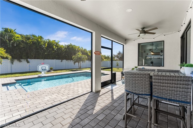 view of pool with a patio and ceiling fan