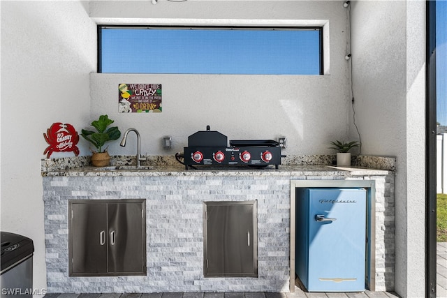 bar with light stone counters and sink