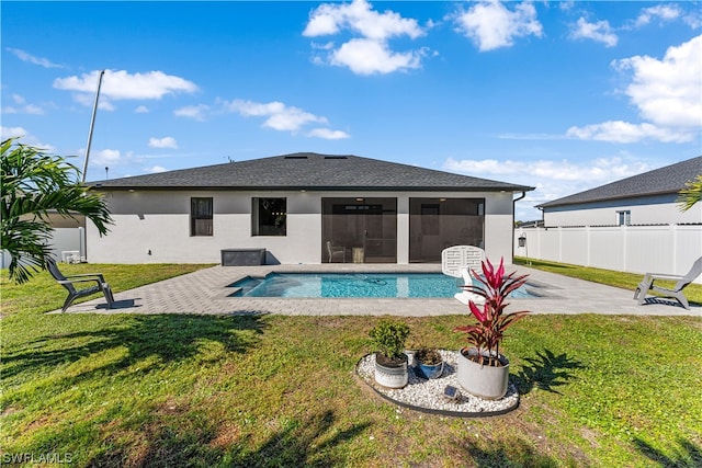 view of swimming pool featuring a lawn and a patio area