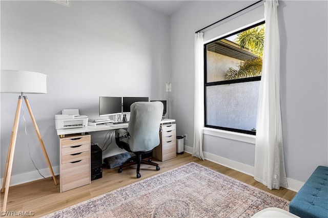 office space with light hardwood / wood-style flooring