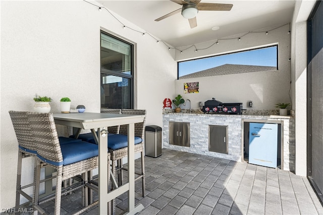 view of patio / terrace with ceiling fan and sink