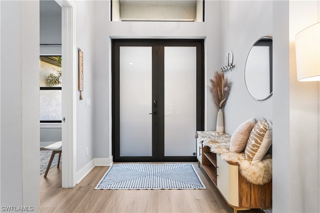 foyer featuring light hardwood / wood-style floors and french doors