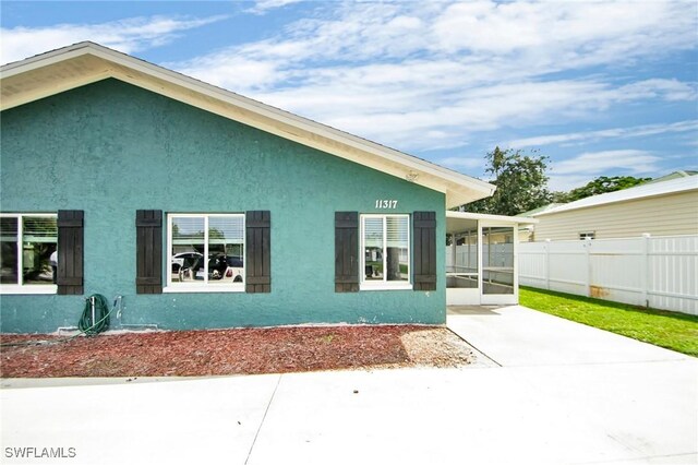 view of side of property featuring a patio