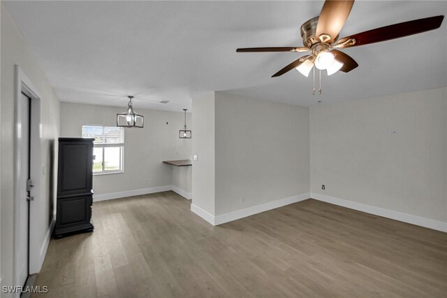 unfurnished living room featuring ceiling fan and wood-type flooring