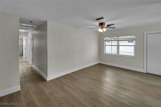 empty room with ceiling fan and hardwood / wood-style floors