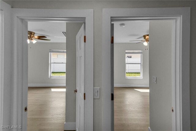 corridor with light hardwood / wood-style flooring