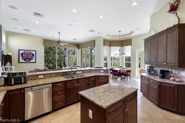 kitchen featuring ceiling fan with notable chandelier, a healthy amount of sunlight, sink, and stainless steel dishwasher