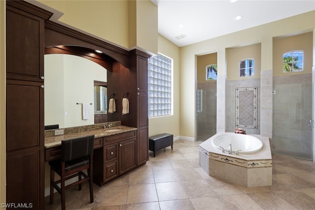 bathroom featuring plenty of natural light, shower with separate bathtub, vanity, and tile floors