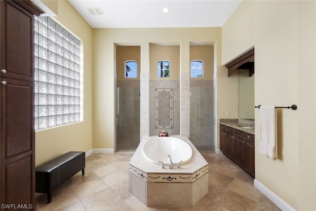 bathroom with vanity, tile flooring, and plus walk in shower