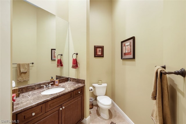 bathroom featuring toilet, tile flooring, and vanity