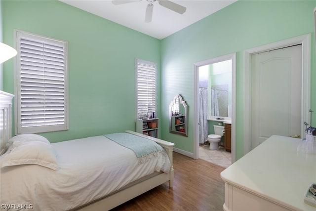 bedroom featuring wood-type flooring, ceiling fan, and ensuite bathroom