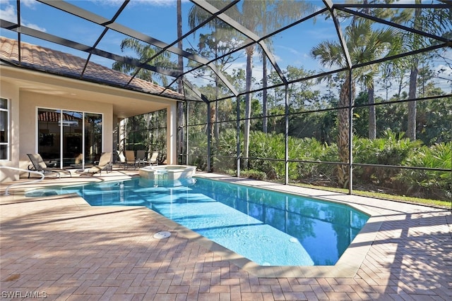 view of swimming pool with an in ground hot tub, glass enclosure, and a patio area