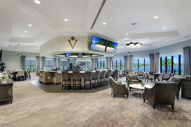 interior space with crown molding, a water view, and a wealth of natural light