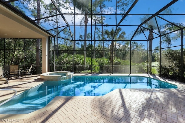 view of pool with an in ground hot tub, a patio, and a lanai