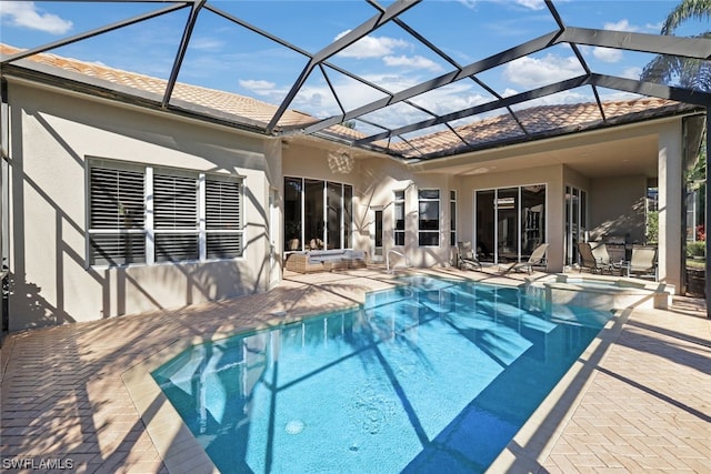 view of pool with a patio and a lanai