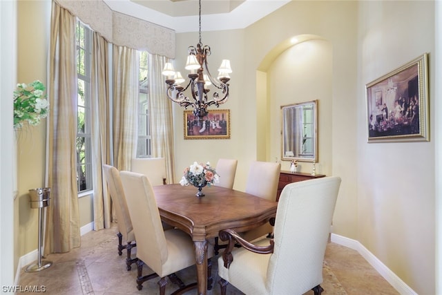 tiled dining space featuring a notable chandelier